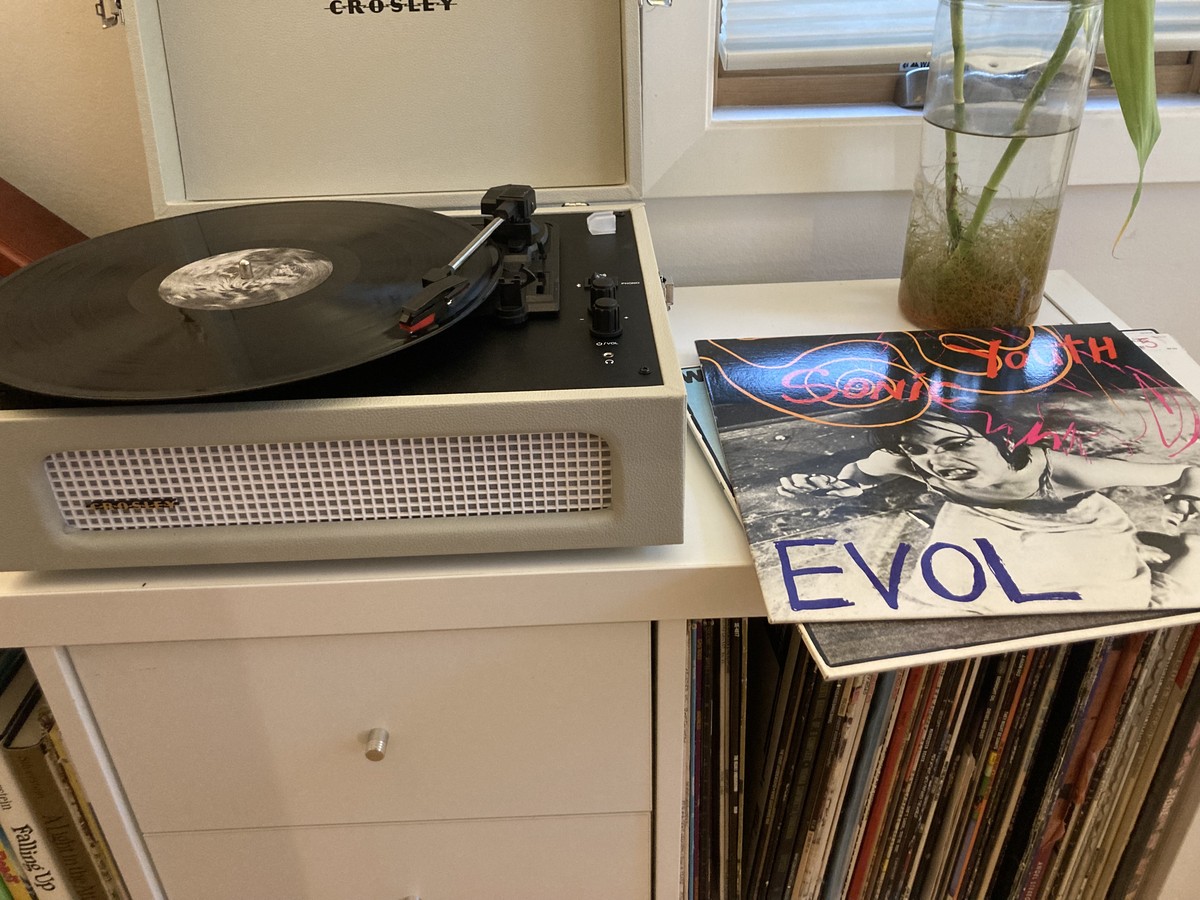 Crossley turntable + speakers, on a shelf next to the sleeve for Sonic Youth: EVOL