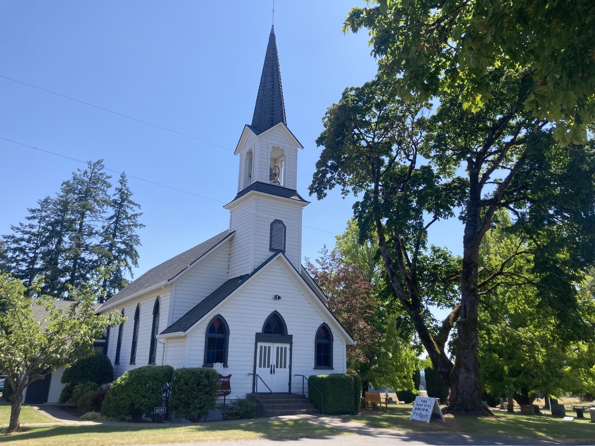 Helvetia Community Church A trim white rural church dating to probably the early 20th century, next to a well-kept cemetery