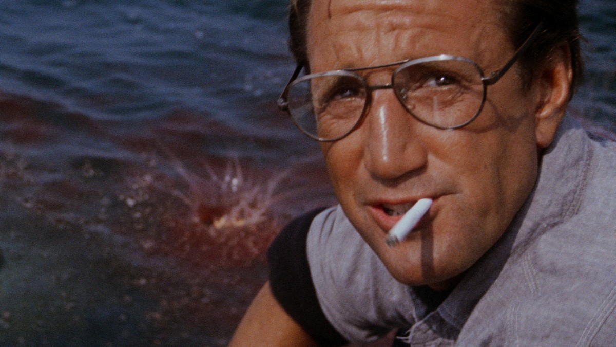Chum this Still from JAWS (1976) where Chief Brody is chumming behind the boat just before the shark appears, for the first time revealing its true size