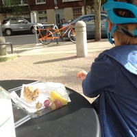 Iris eating a snack and looking at the cargo bike